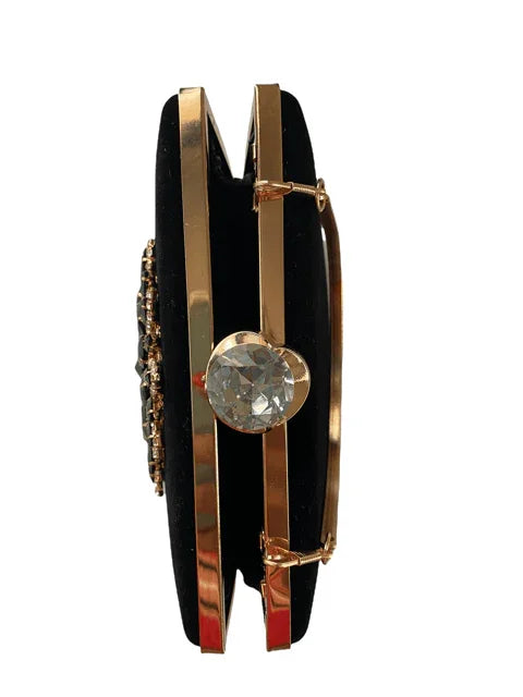 Side view of black velvet evening clutch with gold frame and crystal clasp